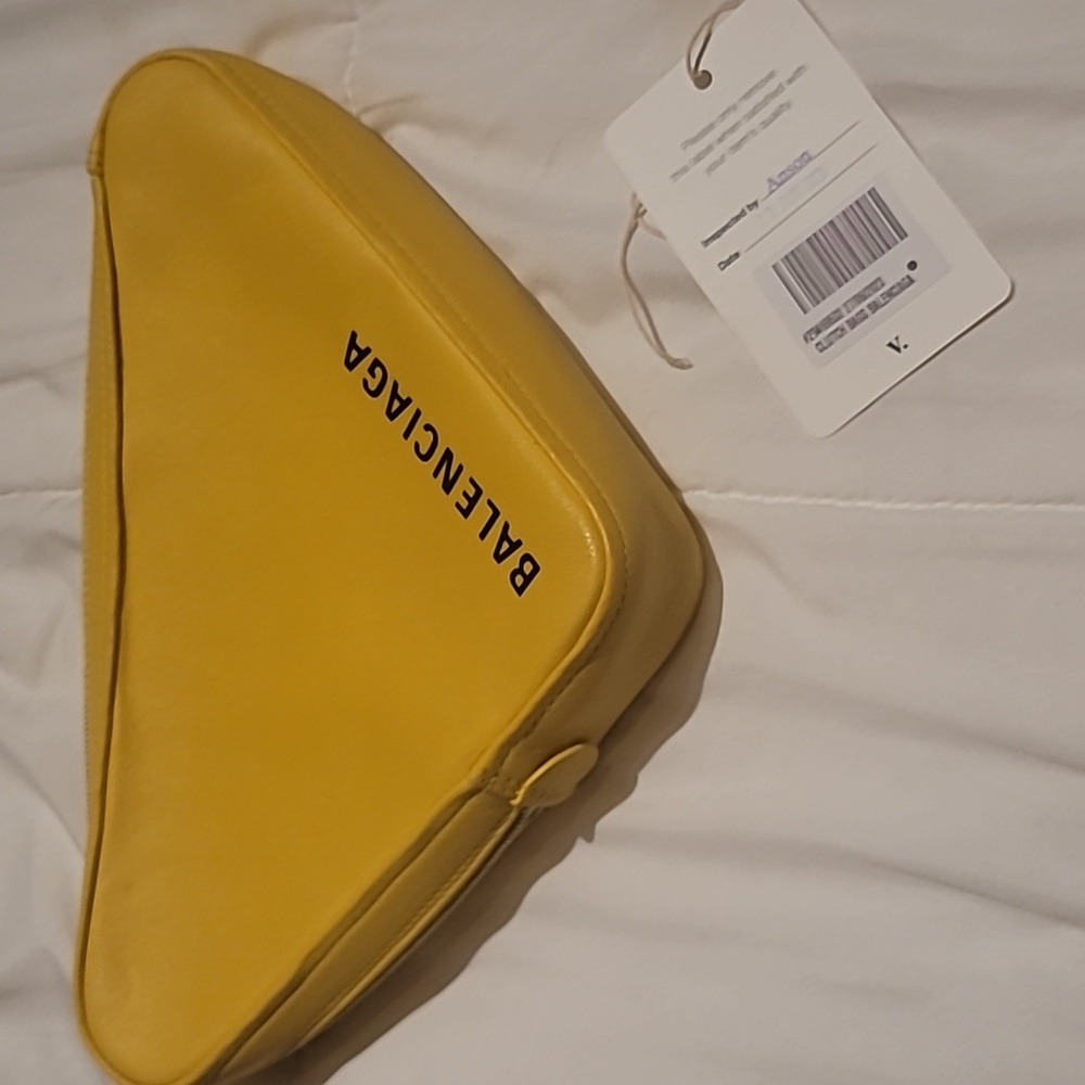 Balenciaga yellow clutch.